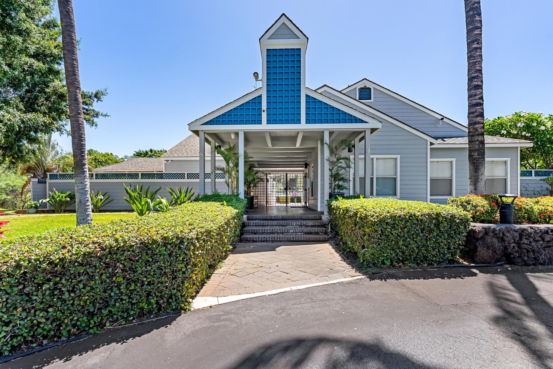 Clubhouse entrance with manicured landscaping