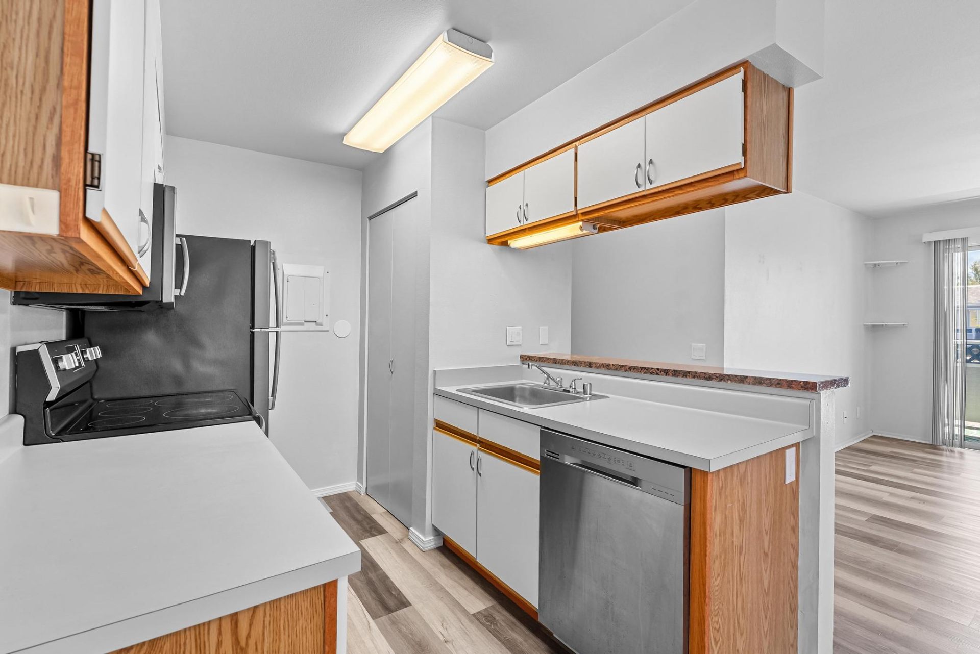 Full kitchen with stainless dishwasher, range, and ample counter space