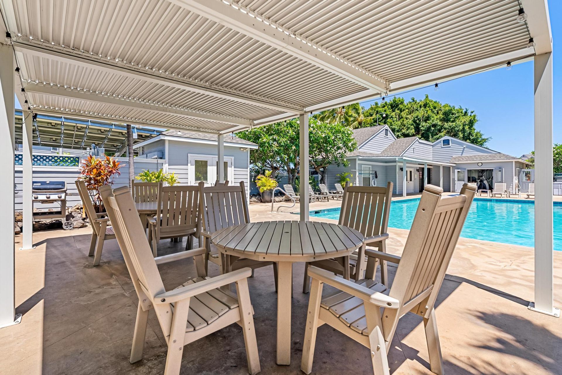 Covered BBQ and dining cabana beside the pool