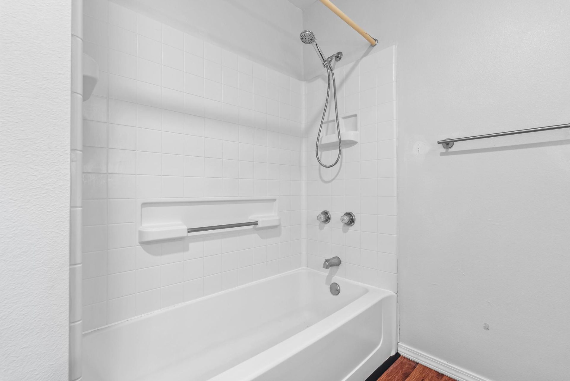 Tub and shower combo with white tile surround