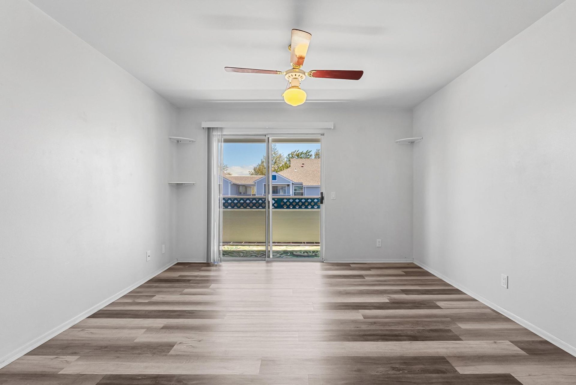 Spacious living room with ceiling fan and lanai access