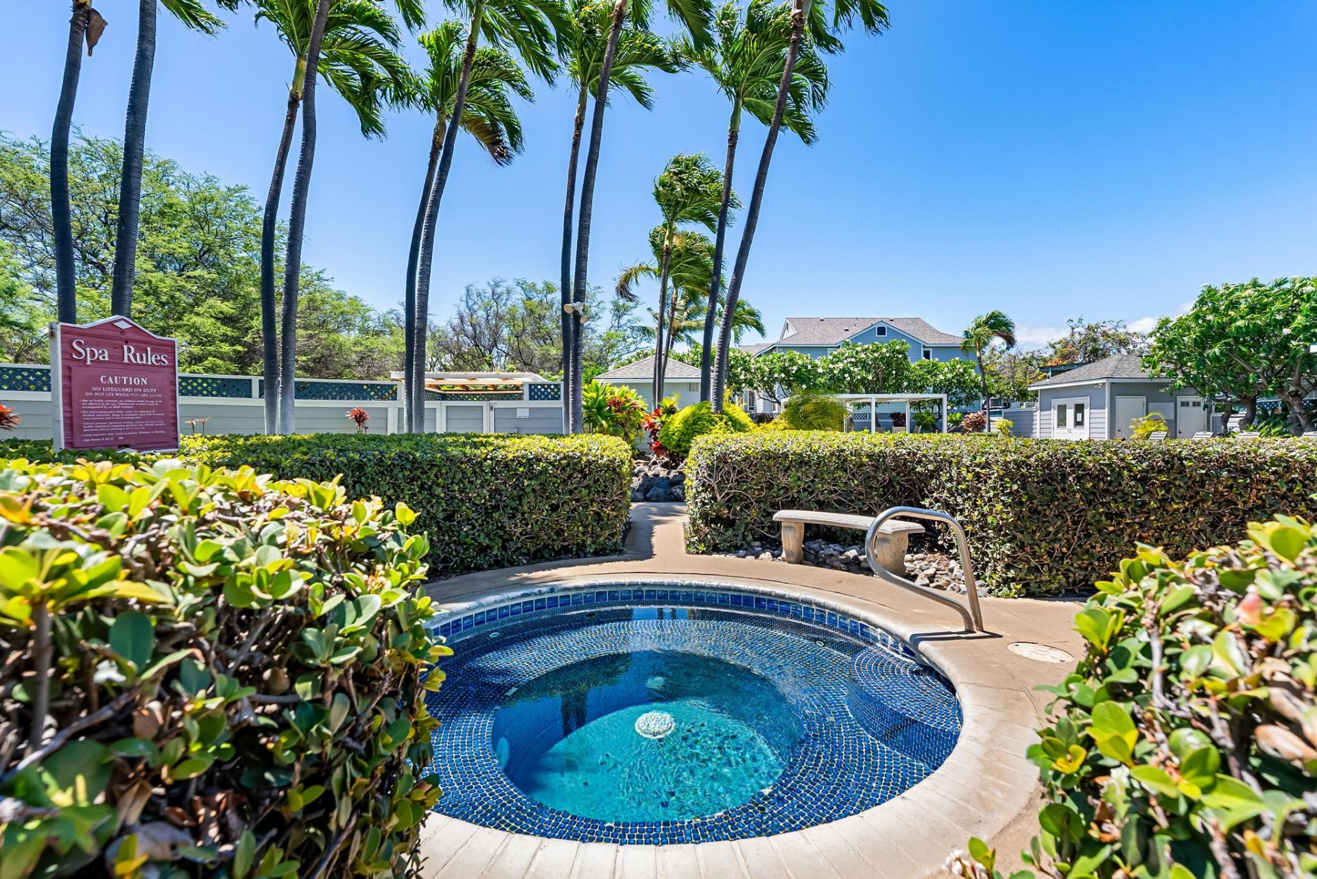 Tiled hot tub spa surrounded by tropical landscaping