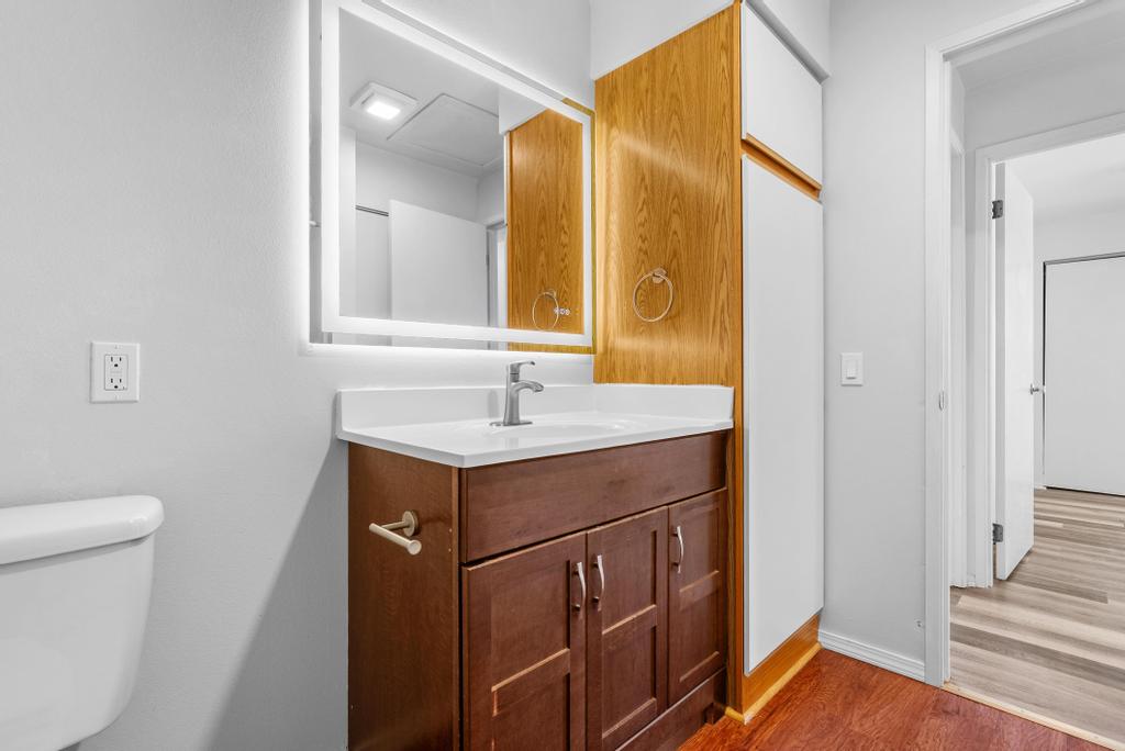 Primary bath vanity with updated faucet and backlit mirror